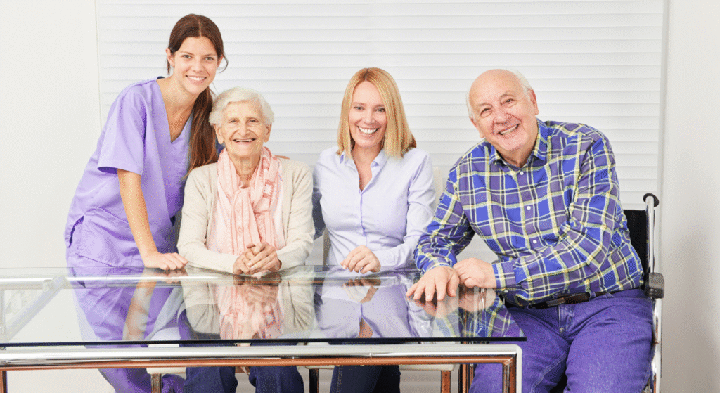 Healthcare worker with happy elderly couple at home.