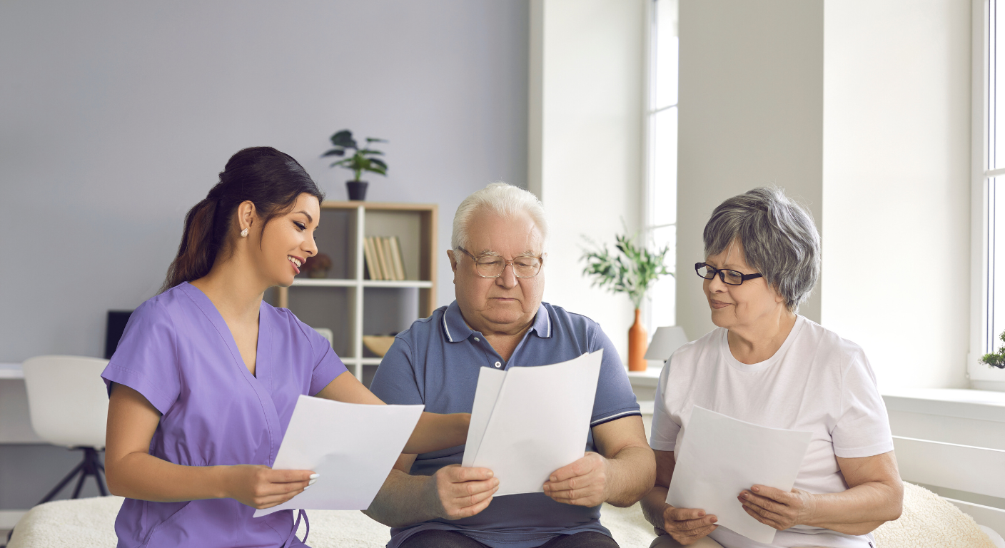 Healthcare worker assisting older couple with documents