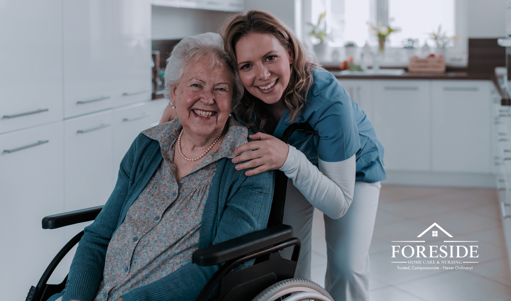 Caregiver smiling with elderly woman in wheelchair