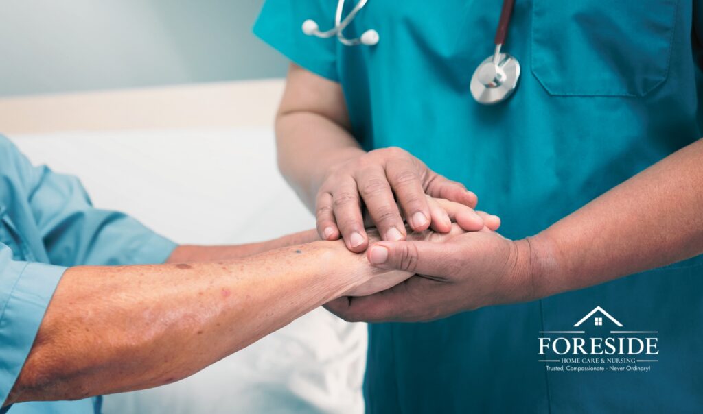 Nurse comforting patient by holding hands.