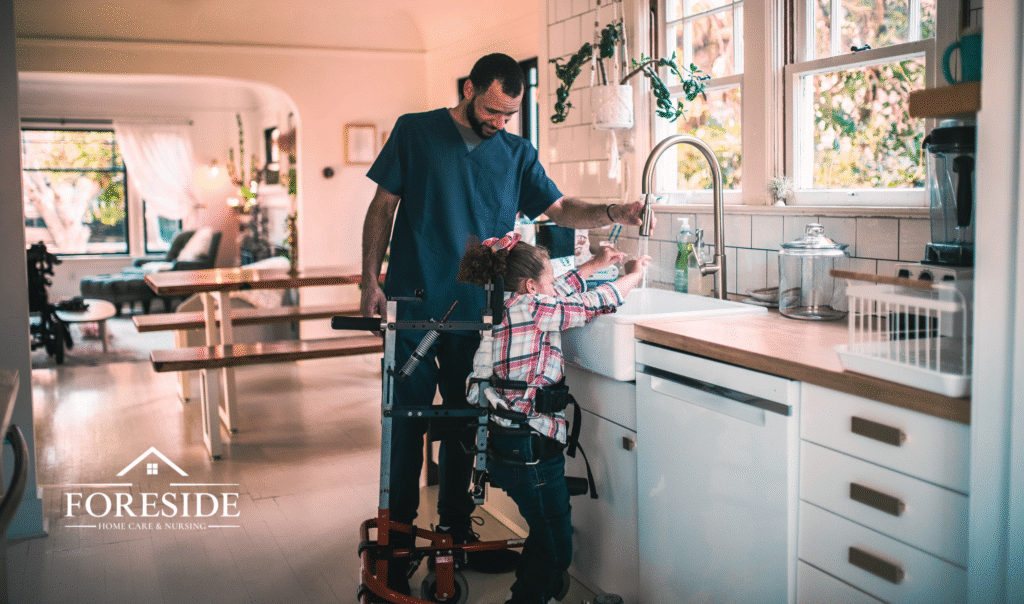 A nurse assists a child with special needs to wash their hands at the kitchen sink.