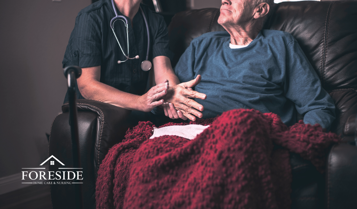 Care worker supporting elderly person at home