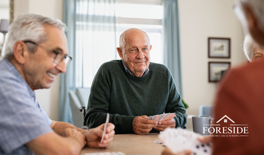 Seniors playing cards at home care facility.