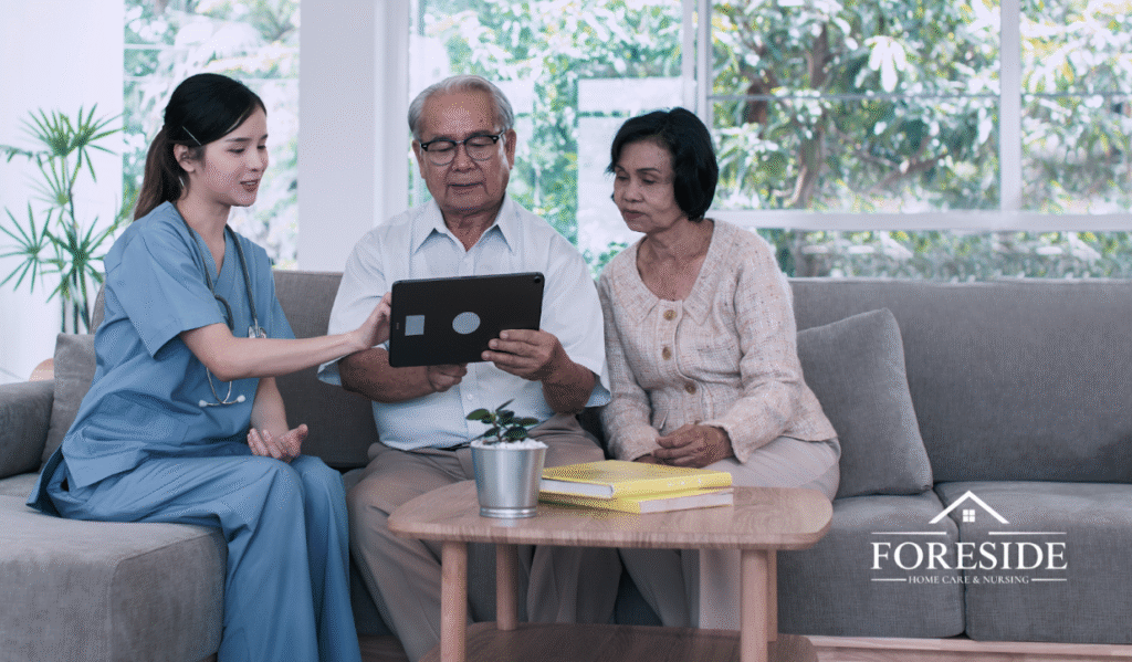 Nurse showing elderly couple something on tablet.