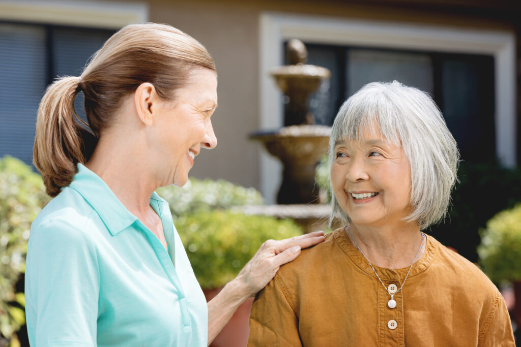 Two women smiling and talking outside