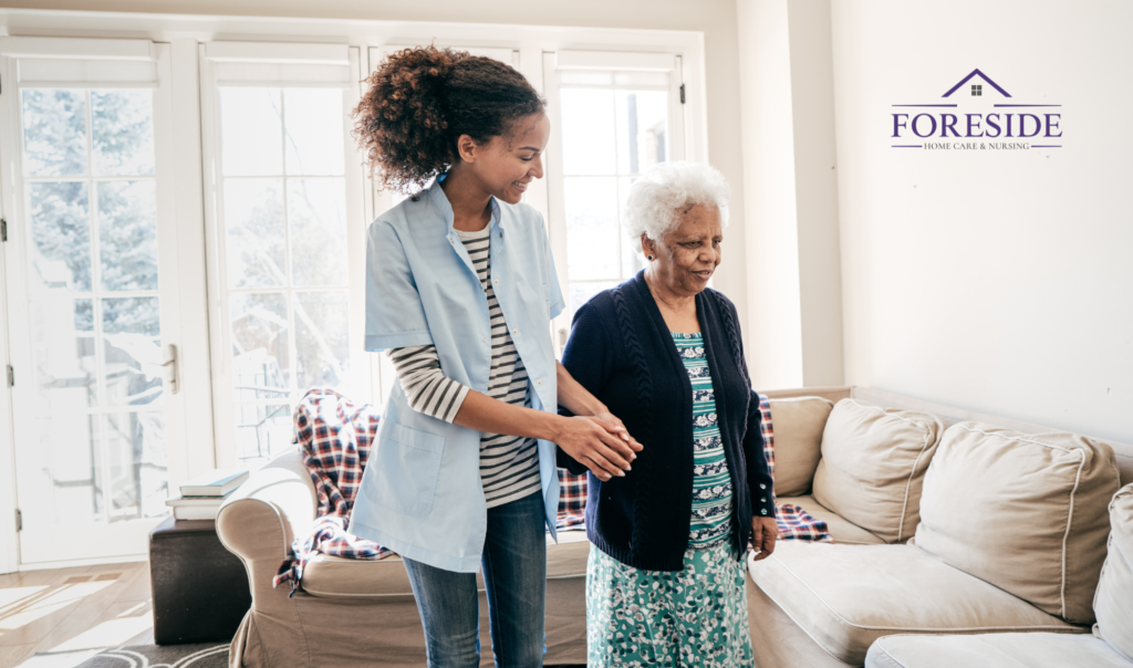 Caregiver assisting elderly woman at home